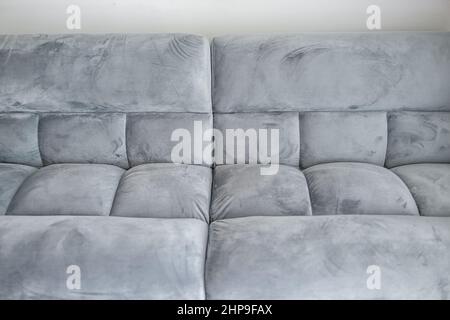 Living room interior with closeup abstract front view of futon couch gray sofa sofabed with microfiber velvet fabric in modern apartment home house Stock Photo