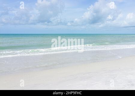Naples beach in Southwest Florida with blue green idyllic water on summer day gulf of mexico coast horizon in paradise landscape nobody Stock Photo