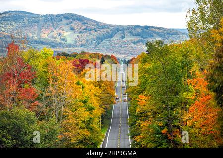 West Virginia road highway with many cars traffic in colorful autumn fall near Blackwater Falls State park and Seneca Rocks with steep ski resort slop Stock Photo