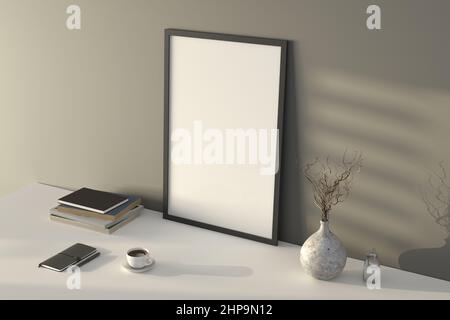 Vertical black picture poster frame mock up. Cup of coffee, books, vase and notebook on white table. Gray wall background. Side view Stock Photo