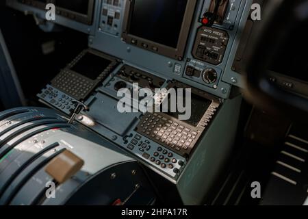 Airplane cockpit with flight displays, switches and knobs Stock Photo