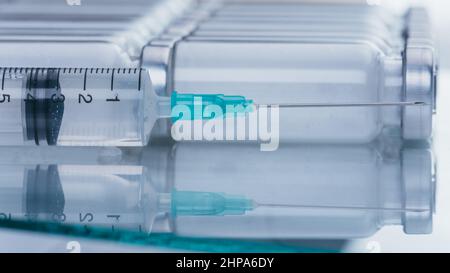 Medicine, Injection, vaccine and disposable syringe, drug concept. Sterile vial medical syringe needle. Macro close up. Glass medical ampoule vial for Stock Photo