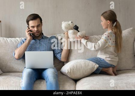 Busy freelance employee father trying to work from home Stock Photo