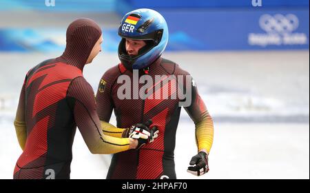 Beijing, China. 20th Feb, 2022. Francesco Friedrich (R) of Germany is seen after the bobsleigh 4-man heat of Beijing 2022 Winter Olympics at National Sliding Centre in Yanqing District, Beijing, capital of China, Feb. 20, 2022. Credit: Yao Jianfeng/Xinhua/Alamy Live News Stock Photo