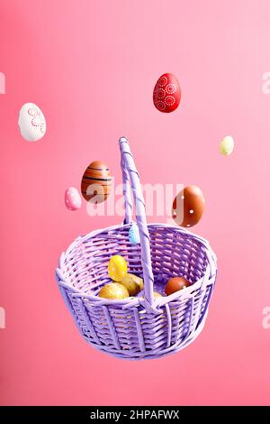 Easter eggs falling into a flying basket, Easter holiday concert Stock Photo