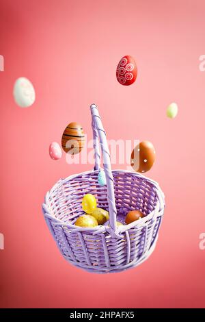 Easter eggs falling into a flying basket, Easter holiday concert Stock Photo
