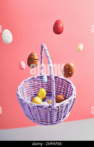 Easter eggs falling into a flying basket, Easter holiday concert Stock Photo