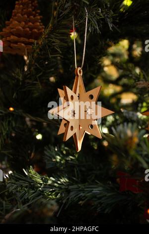 New Year's toy made of wood on the background of the Christmas tree Stock Photo