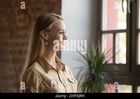 Smiling dreamy beautiful young woman looking in distance. Stock Photo