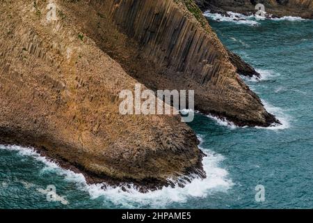 Aerial from helicopter showing columnar basalt rock formation, Hong Kong Global Geopark, Sai Kung East Country Park Stock Photo