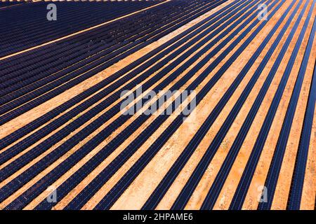 Broken hill power plant of endless solar panels on a electricity generation farm - aerial top down view. Stock Photo