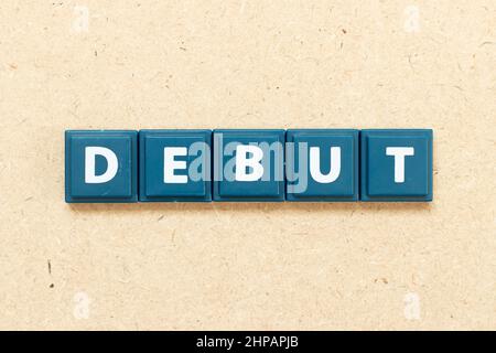 Tile alphabet letter in word debut on wood background Stock Photo
