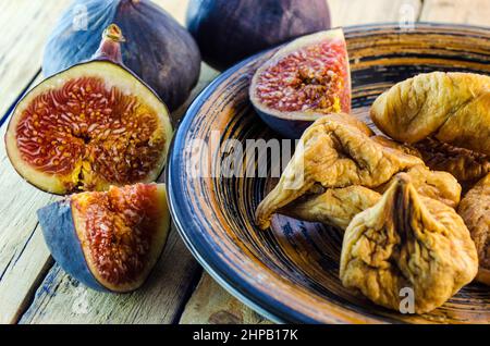 fresh and dried figs on a wooden table Stock Photo