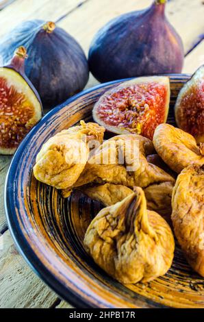 fresh and dried figs on a wooden table Stock Photo