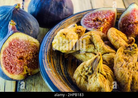 fresh and dried figs on a wooden table Stock Photo
