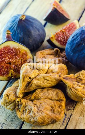 fresh and dried figs on a wooden table Stock Photo
