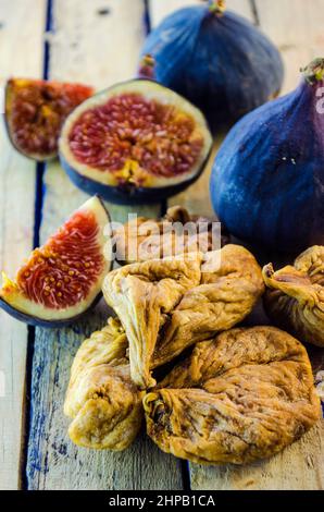 fresh and dried figs on a wooden table Stock Photo