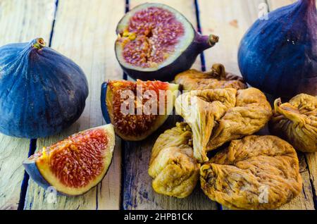 fresh and dried figs on a wooden table Stock Photo