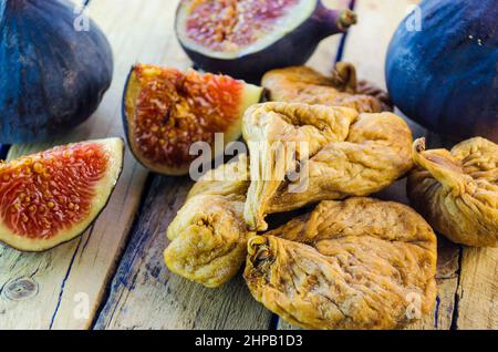 fresh and dried figs on a wooden table Stock Photo