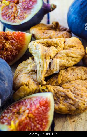 fresh and dried figs on a wooden table Stock Photo
