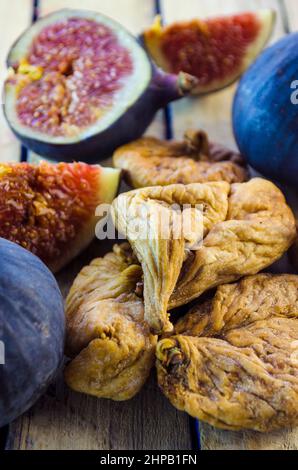 fresh and dried figs on a wooden table Stock Photo