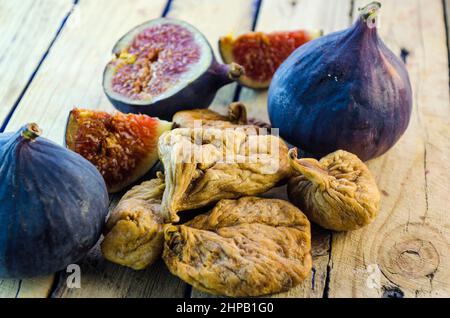 fresh and dried figs on a wooden table Stock Photo
