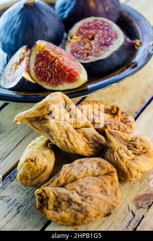 fresh and dried figs on a wooden table Stock Photo
