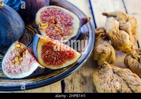 fresh and dried figs on a wooden table Stock Photo