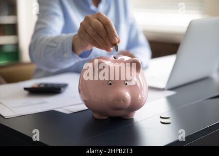 Close up cropped middle aged mature woman saving money. Stock Photo