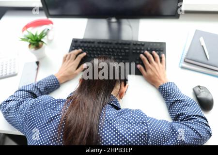 Overworked tired female freelancer or remote worker sleep lying on desk Stock Photo