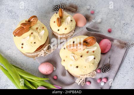 Composition with tasty Easter cakes, eggs and candies on light background Stock Photo