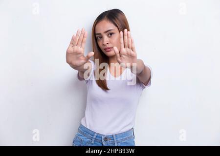 beautiful young woman with open hand doing stop sign with serious expression defense gesture isolated on white background Stock Photo