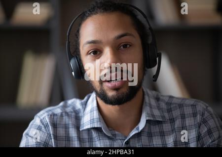 Head shot focused smart young African American businessman holding videocall. Stock Photo