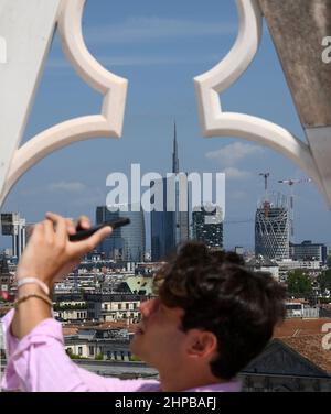 (220220) -- MILAN, Feb. 20, 2022 (Xinhua) -- A tourist takes photos on the terrace of Duomo di Milano in Milan, Italy, on Aug. 6, 2021. Italian cities Milan and Cortina d'Ampezzo were appointed hosts of the 2026 Winter Olympic Games at the 134th session of the International Olympic Committee (IOC) on June 24, 2019. The 2026 Winter Olympic Games will be the third time Italy hosts the Winter Olympics, following Turin in 2006 and Cortina d'Ampezzo in 1956. (Photo by Alberto Lingria/Xinhua) Stock Photo