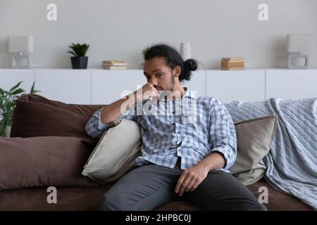 Stressed young African American man feeling unhappy. Stock Photo