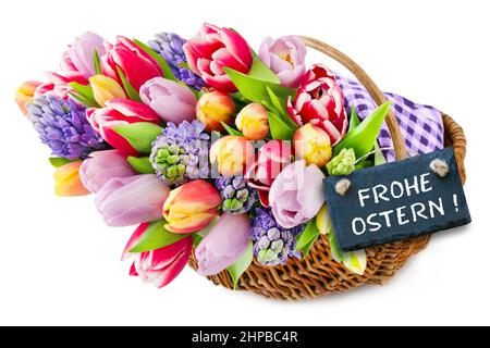 Label and German Happy Easter with colorful springtime flowers in a basket on white background Stock Photo