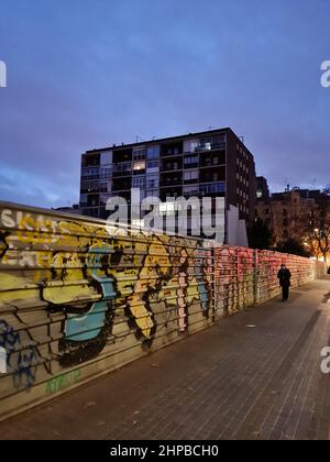 Metallic wall with graffiti on in a street at dusk. Barcelona, Catalonia, Spain. Stock Photo