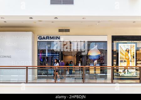 Miami, USA - July 19, 2021: Sign for Garmin store shop selling watches and modern sports technology inside of Aventura shopping mall in Florida, Unite Stock Photo