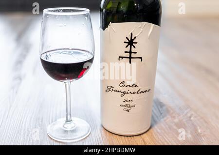 Naples, USA - August 10, 2021: Bottle of 2015 vintage Italian Italy red wine from Conte Giangirolamo with paper label on table Stock Photo
