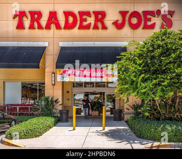 Naples, USA - August 7, 2021: Naples, Florida Trader Joe's grocery store sign entrance with candid people and text for flyer has landed Stock Photo