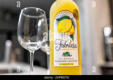 Naples, USA - August 27, 2021: Fabrizia Limoncello brand all natural liqueur liquor bottle on table with glass made with Italian lemons in New Hampshi Stock Photo