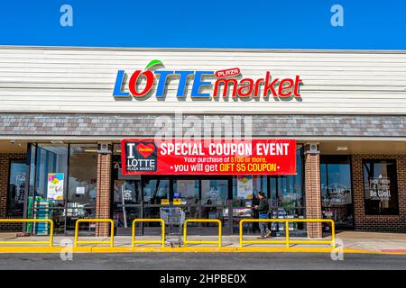 Herndon, USA - March 9, 2020: Street road strip mall with exterior facade of Lotte Asian Korean market store building selling produce in Virginia Fair Stock Photo