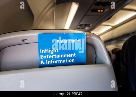 Washington DC, USA - August 25, 2021: Airplane plane seat point of view in American Airlines flight with inflight entertainment information booklet bl Stock Photo