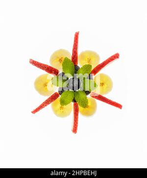 Fresh strawberries, blueberries and banana arranged on white background Stock Photo