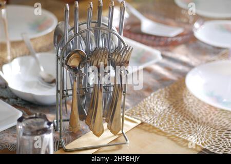 empty plate, table napkin with knife and fork on table. Stock Photo