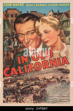 JOHN WAYNE and BINNIE BARNES in IN OLD CALIFORNIA (1942), directed by WILLIAM MCGANN. Credit: REPUBLIC PICTURES / Album Stock Photo