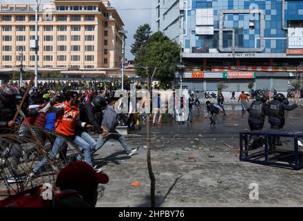 Riot police (R) run for cover as demonstrator’s hurls stones towards them during a protest against the $500 million U.S infrastructure grant under the Millennium Challenge Corporation (MCC) near the parliament in Kathmandu, Nepal February 20, 2022. REUTERS/Navesh Chitrakar