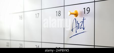 Doctors appointment concept in German. A calendar with an entry 'Arzt' (Doctor) and a thumbtack. Selective focus. Web banner format Stock Photo