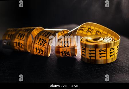Centimeter of yellow color on a dark background. Length measuring tool Stock Photo