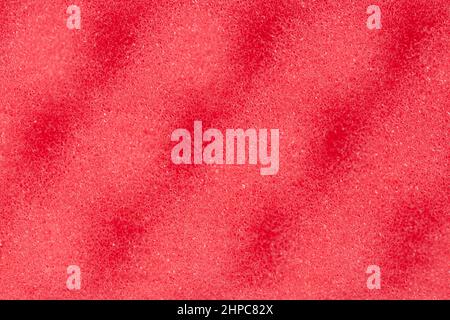 Red sponge textured background. Foam rubber background. Stock Photo